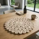 360 HOME PLACEMAT STRAW 38CM LACY DESIGN WITH A CENTRAL MOTIF AND A DECORATIVE OUTER EDGING THAT INCLUDES SHELL OR PICOT STITCHES OFF-WHITE