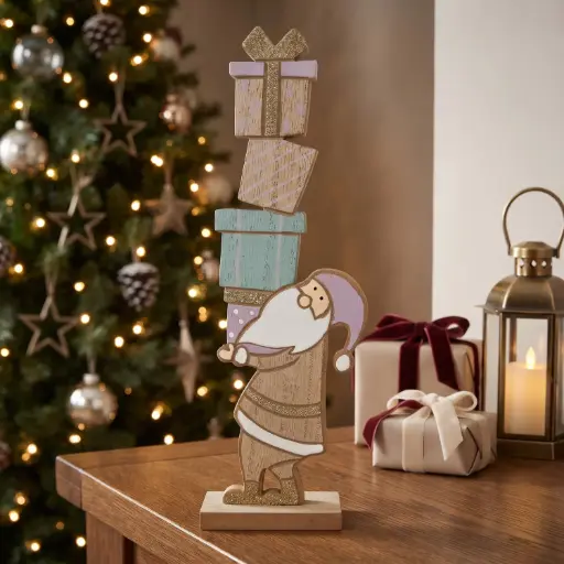 [CH26-WD32] 360 HOME CHRISTMAS MDF DECOR, 7*5*24 whimsical Christmas tabletop decoration featuring Santa carrying a tall stack of presents.